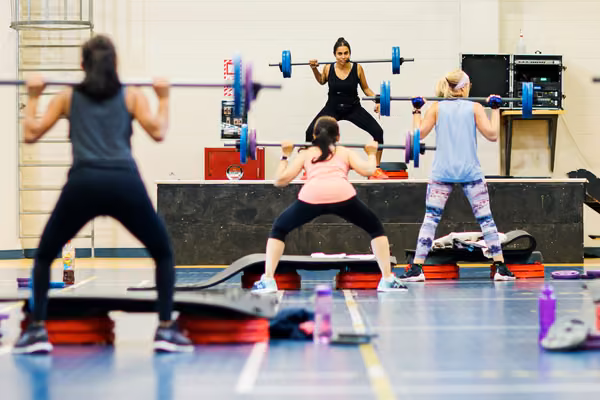 Mixed gender group fitness class in progress