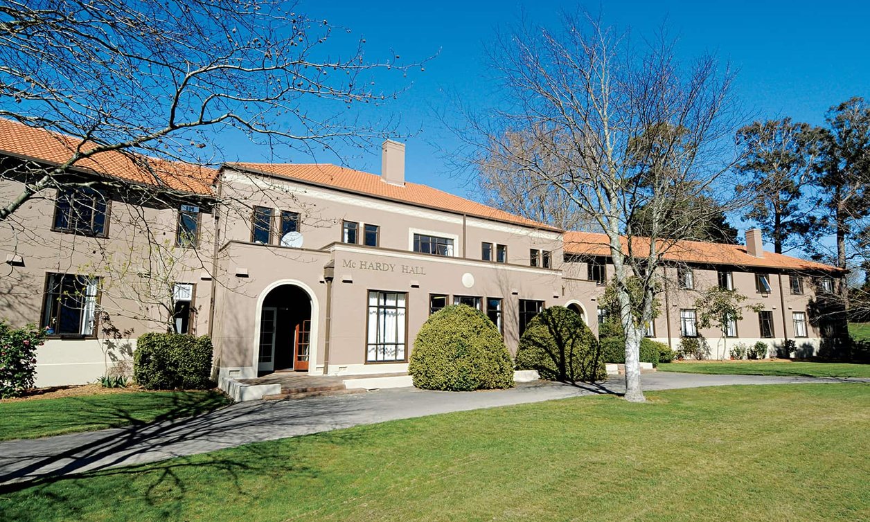 Exterior of McHardy Hall with deciduous trees in the foreground