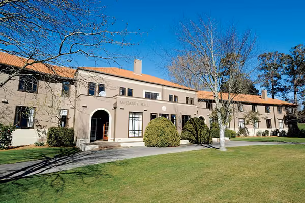 Exterior of McHardy Hall with deciduous trees in the foreground