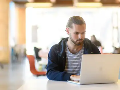 Distance student studying on laptop