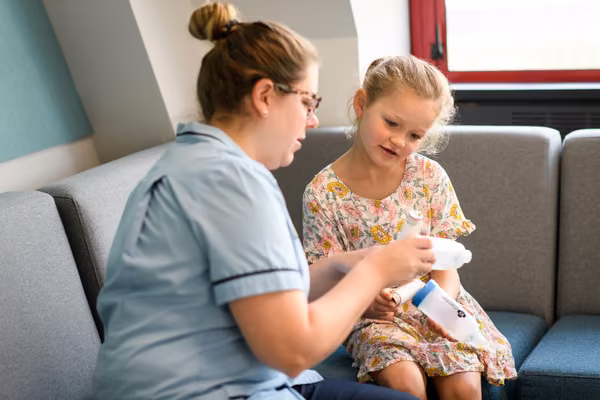 Nurse listening to a child's chest with a stethoscope