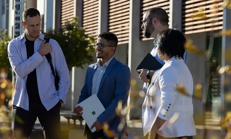 Massey business school students having discussion outside.