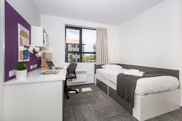 Single bedroom in Massey Halls, Albany Campus, with a bed, study desk and chair