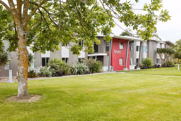 Exterior of Matai, Miro, Tawa and Totara Halls with a large shade tree in the foreground