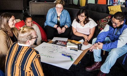 Student group enjoying learning together in a public lounge