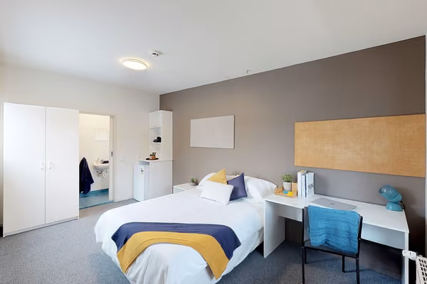 Wellington whare single room with a bed, wardrobe, ensuite and study desk