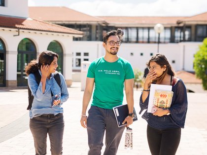 Three students walking through Massey Auckland campus.