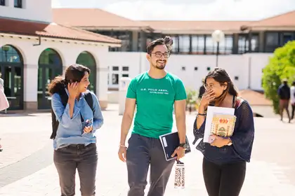 Three students walking through Massey Auckland campus.