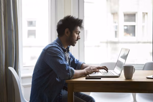 Man on laptop at his home