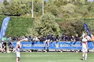 supporters cheering on the side lines