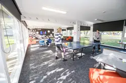 Lounge in Colombo Hall with two students playing a game of pool