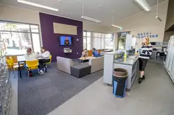 Matai, Miro, Tawa and Totara Halls' lounge area with a kitchenette and couches arranged in a semi-circle