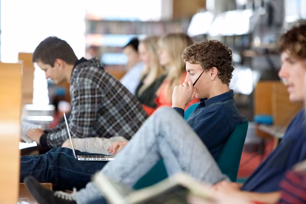 Small group of students listening to a speaker
