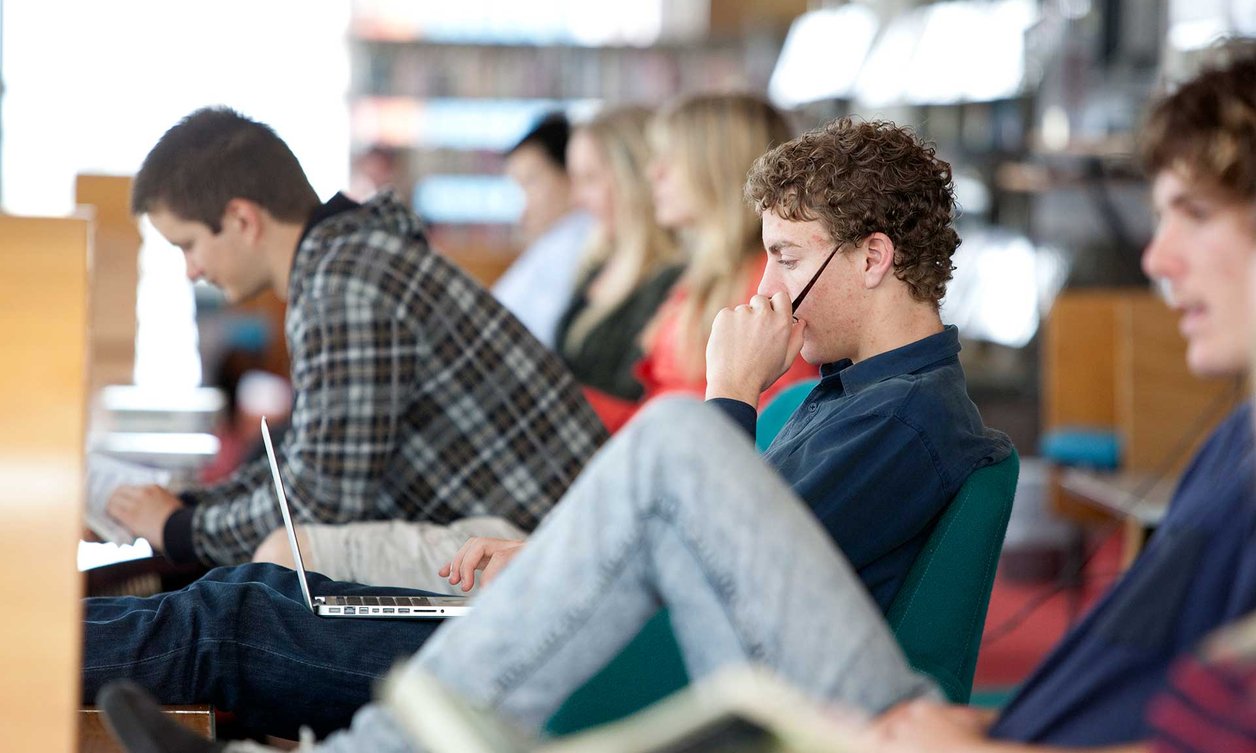 Small group of students listening to a speaker