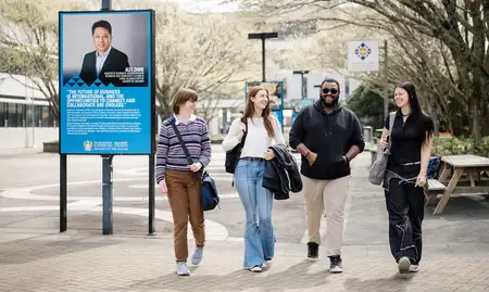 Four students walking outside on the Manawatū campus.