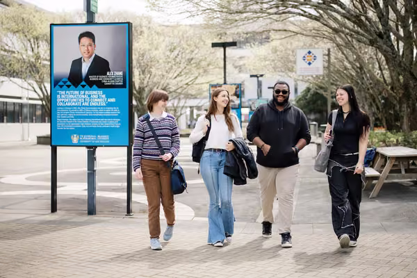 Four students walking outside on the Manawatū campus.