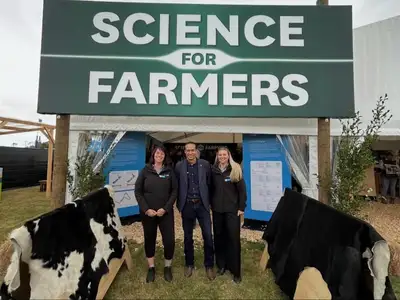 three people standing outside science for farmers tent at fieldays