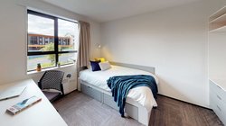 Matipo, Titoki and Tānekaha apartments' single bedroom with bed, desk and chair