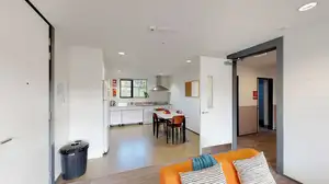 Matipo, Titoki and Tānekaha apartments' kitchen with small dining table and chairs