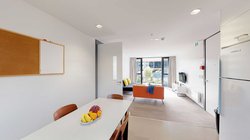 Matipo, Titoki and Tānekaha apartments' kitchen with dining table and chairs