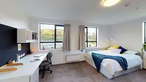 Matipo, Titoki and Tānekaha apartments' double bedroom with bed, desk and chair
