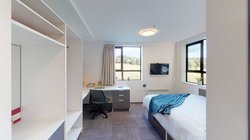 Studio unit with a bed, desk, chair and built-in storage