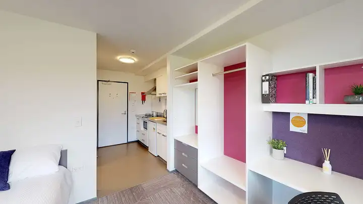 Studio Unit with bed, desk, wardrobe, and kitchenette