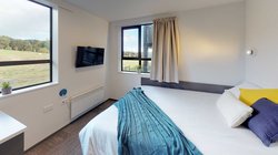 Studio Unit with double bed, wall mounted TV, and rural views