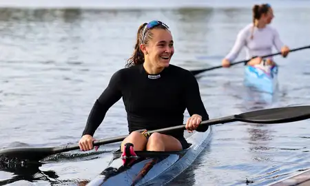 Alicia Hoskin smiling while sitting in her kayak.