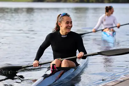 Alicia Hoskin smiling while sitting in her kayak.