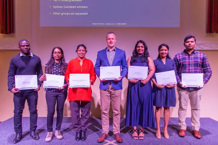 Group of awardees holding certificates