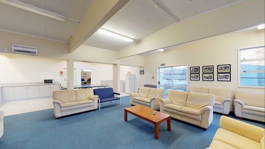 Interior of Atawhai Flats common room, with 7 couches and a coffee table