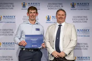 Award winner Ben Carroll holding his certificate alongside Daniel Chapman from Aviagen at the Massey Agriculture Awards.