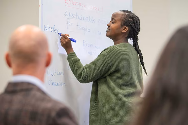 Person writes on a whiteboard