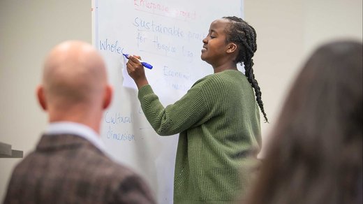 Person writes on a whiteboard
