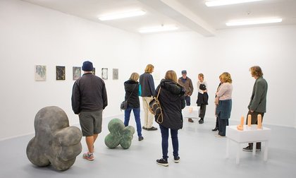 People looking at exhibits at College of Creative Arts Exposure event