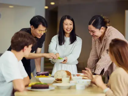 People gathered around a table sharing healthy food.