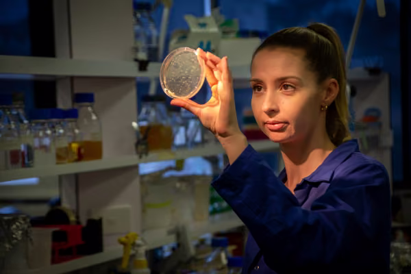 Women looking a petri dish