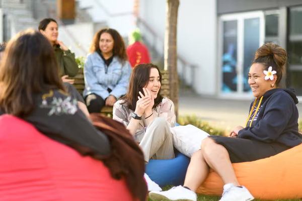 Massey students sitting outside at the Manawatū campus