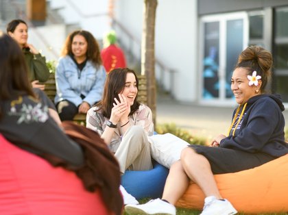 Massey students sitting outside at the Manawatū campus