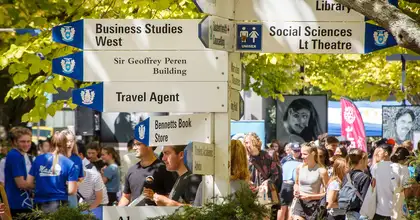 Close-up of signpost and students at Orientation