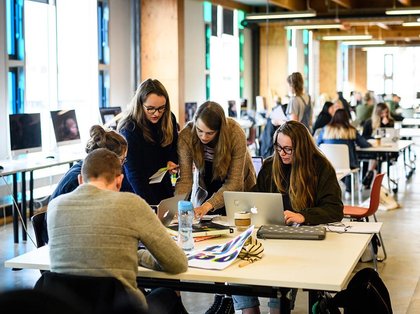 People working around a computer in a studio