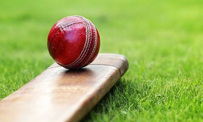 Close-up of cricket ball and bat