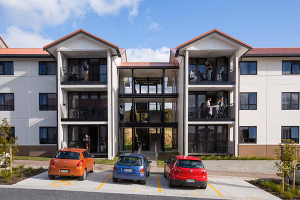 Row of Matipo, Titoki and Tānekaha apartments with cars parked outside