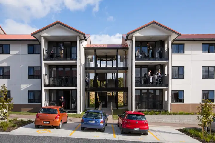 Row of Matipo, Titoki and Tānekaha apartments with cars parked outside