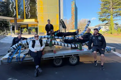 group of people standing outside building sitting on trailer