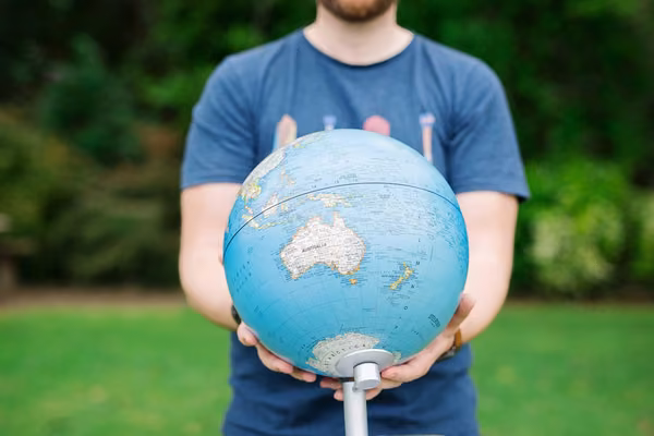 Person showing us Oceania on a globe