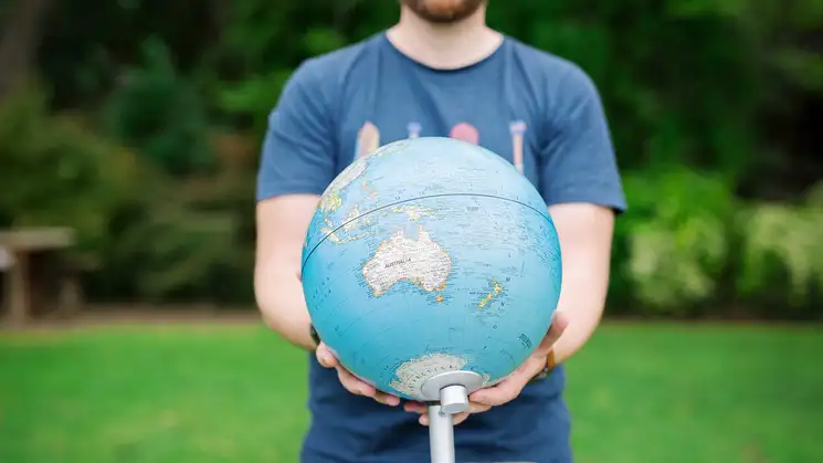 Person showing us Oceania on a globe