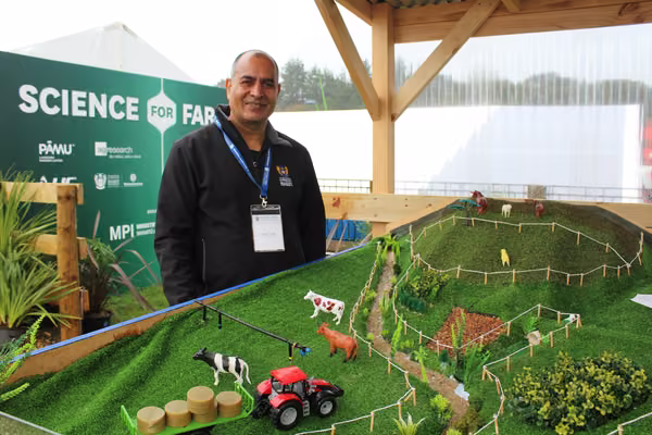 man standing in front of mock-up of a farm