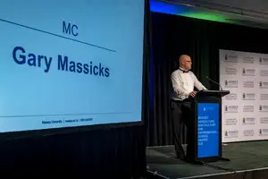 Gary Massicks speaking at the podium as MC of the 2026 Massey Agriculture Awards.